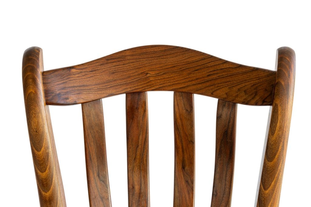 Close-up view of dark grain features and craftsmanship on a custom Walnut rocking chair.