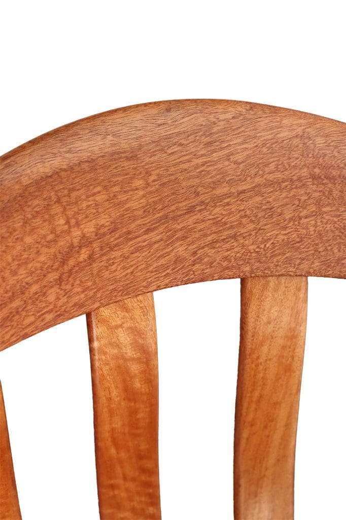 Close-up detail of the grain structure and compound curves on a Queensland Maple rocking chair.